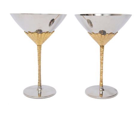 Stuart Devlin for Viners, a pair of stainless steel and gilt wine goblets conical bowls on textured stems, the bases marked V