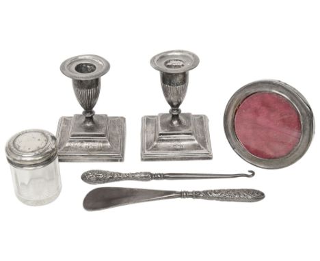 A pair of late Victorian silver dwarf candlesticks, a photograph frame and other silver itemsfirst London, 1897, Horace Woodw