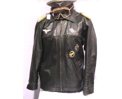 A Post WWII Luftwaffe arrangement comprising a badged leather bomber jacket (size M), with epaulettes and awards, together wi