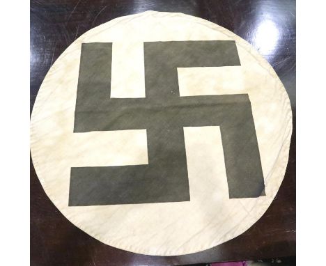 A Third Reich trophy flag roundell, being a white cotton disc with printed black Swastika, D: 17 cm, light fading and discolo