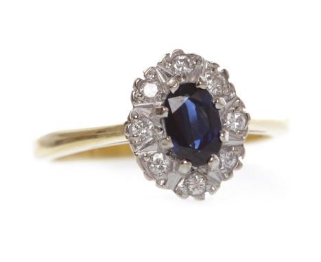 EIGHTEEN CARAT GOLD SAPPHIRE AND DIAMOND CLUSTER RINGset with a central oval sapphire surrounded by round diamonds in illusio