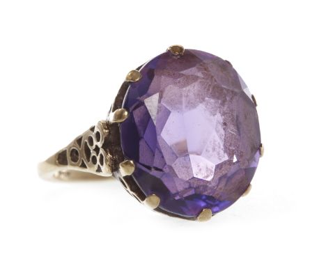 LARGE AMETHYST DRESS RINGset with a single oval amethyst 16mm long, pierced gallery, in nine carat gold, size K-L, 6.2g