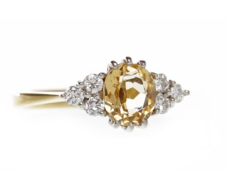 EIGHTEEN CARAT GOLD GEM AND DIAMOND DRESS RINGset with a central oval yellow gem flanked by two groups of three round diamond