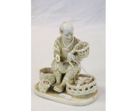 Vintage Japanese Faux Ivory Porcelain model of a seated Fisherman with baskets etc, stands approx 14cm 