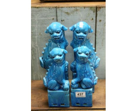 Two Pairs of Chinese Turquoise Blue Glazed Ceramic Seated Dogs of Foe, 33cms high and 26cms high