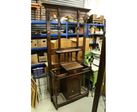 Early 20th century Oak Hall Stand, the upper section with Six Iron Hooks over a Glove Drawer flankled with side by stickstand