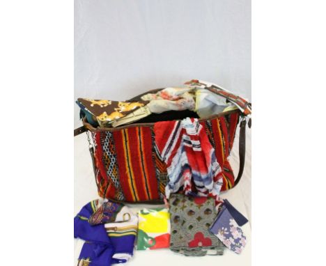 Carpet bag of mixed fabrics etc to include Scarves, tea towels, Handbags etc