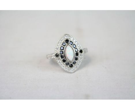 Silver lozenge shaped ring set with CZ's Sapphires and central opal panel