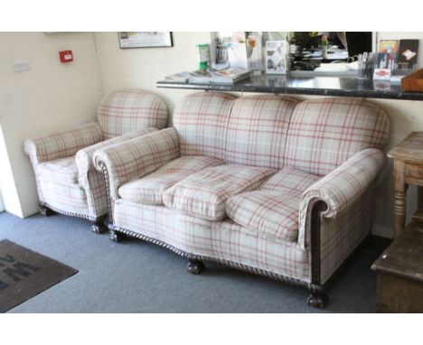 Early 20th century Carved Oak Framed Three Seater Sofa and matching Armchair, raised on large carved ball and claw feet, sofa