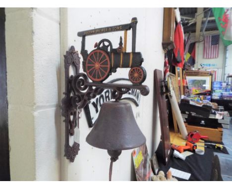 A cast iron wall mounted bell displaying a Joseph Brewer & Sons tractor. Estimate £20 - £40 This lot MUST be paid for and col