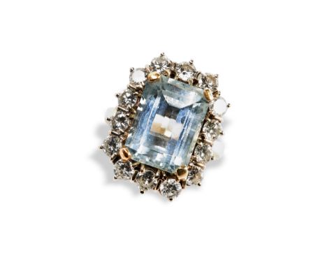 AN AQUAMARINE AND DIAMOND RING the emerald cut, cut corner claw set aquamarine, surrounded by 14, claw set, round brilliant c