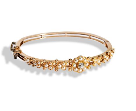 A VICTORIAN SEED PEARL AND DIAMOND BANGLE&nbsp; the upper section set with a central round cut diamond within a seed pearl bo