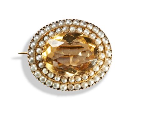 A VICTORIAN CITRINE AND SEED PEARL BROOCH, CIRCA 1870 an oval cut citrine within two stepped borders of seed pearls, brooch p
