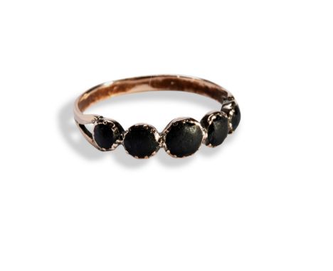 A 19TH CENTURY JET FIVE STONE RING five, bezel set, jet cabochons graduating in size, to split shoulders. Unmarked Ring size 