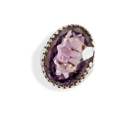 A SINGLE STONE OVAL AMETHYST RING with a claw set wit an oval amethyst set in silver on a later gold shank. Marked 9ct, Birmi