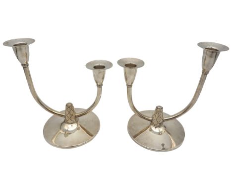 A PAIR OF STYLIZED SILVER DUAL LIGHT CANDLESTICKS, designed by A.Edward Jones Ltd for Garrard &amp; Co,&nbsp;two asymmetric c