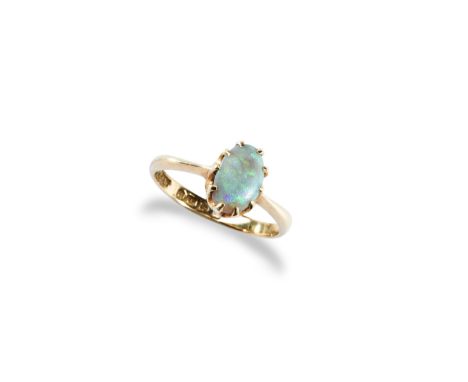 AN OPAL SOLITAIRE RING the claw set oval opal cabochon being set between tapering shoulders.&nbsp; Hallmarked 18, Chester, 19