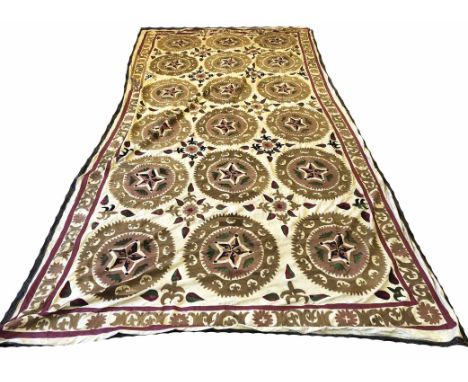 VINTAGE UZBEK SUZANI, 445cm x 223cm, repeat medallions within a complimentary border.