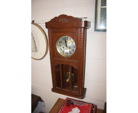 An oak cased wall clock