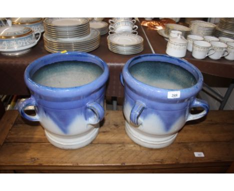 A pair of blue ceramic planters