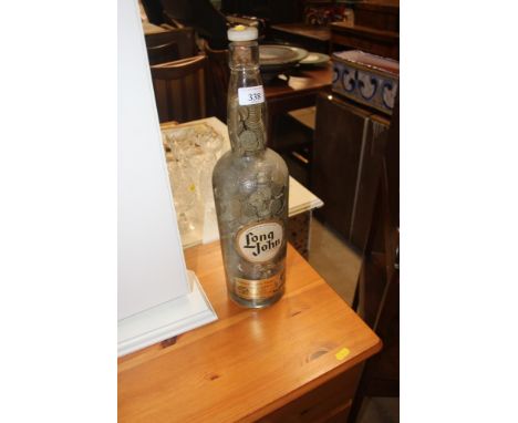 An Old Scotch Whiskey bottle and contents of coins