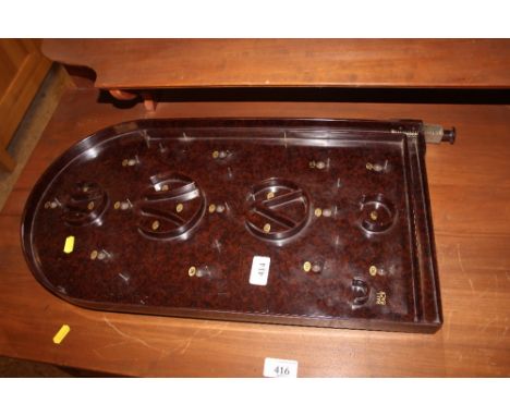 An Art Deco Bakelite bagatelle board