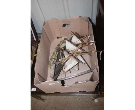 A box containing a wooden model boat and a KB radio dealer sign