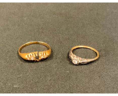 An 18ct gold diamond five stone ring (missing one stone) size R, 2.5g gross;  another solitaire ring, size K, 2.2g gross (2) 