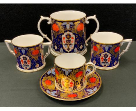 A Derby Ceramic Art Studios Hamilton Imari twin handle loving cup;  another smaller;  coffee can and saucer etc 