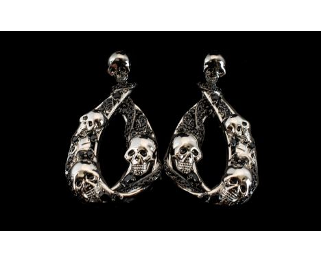 Skull and Black Spinel Snake Large Drop Earrings, skull shaped studs with post and push back fittings, each holding a long, o