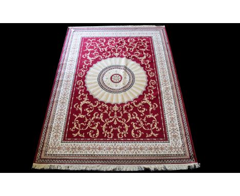 A Large Woven Silk Carpet Abusson rug with red ground and  with traditional floral and foliate border detail with central sun