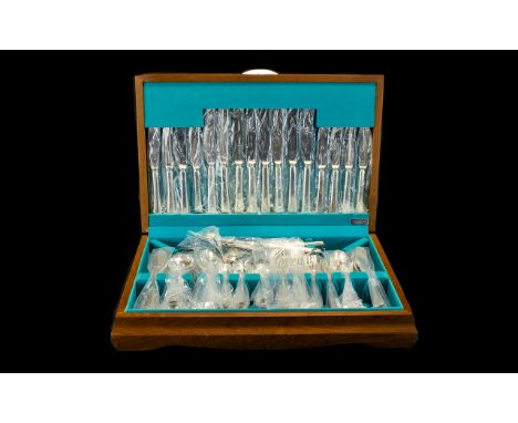 Boxed Set of Cutlery housed in an attractive wooden box.  Contains place settings for eight, including knives, forks, spoons,