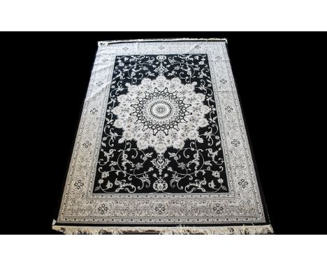 A  Large Woven Silk Carpet Keshan rug with black ground and grey border with traditional floral and foliate detail with centr