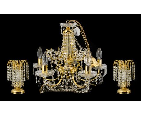 A Gilt Metal And Crystal Ceiling Pendant Five branch light fitting with gilt arts, cut glass column, fluted bobeche and multi