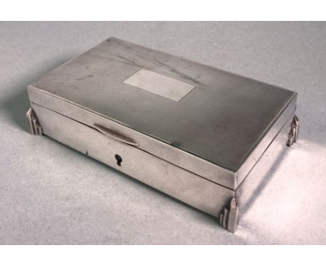 rectangular with engine-turned decoration to hinged cover, stepped feet,  15cm wide.  
