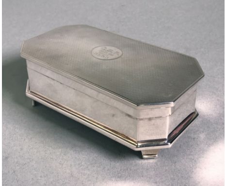 rectangular with canted corners, the hinged cover with engine-turned decoration and an engraved cartouche, bracket feet, velv
