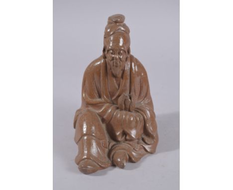 A CHINESE GLAZED POTTERY SEATED FIGURE, 22cm high.