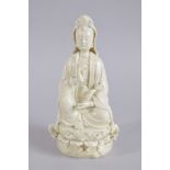 AN EARLY 20TH CENTURY DEHUA PORCELAIN GUANYIN, with two impressed seal marks to the reverse, 27cm