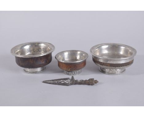 THREE TIBETAN MONGOLIAN SILVER MOUNTED BOWLS, the largest embossed dragon and precious objects, 12cm diameter, together with 