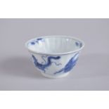 A CHINESE KANGXI PERIOD BLUE AND WHITE PORCELAIN TEA CUP, painted with phoenix, base with mark, 7.
