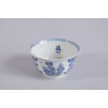 A 17TH CENTURY CHINESE KANGXI PERIOD BLUE AND WHITE PORCELAIN TEA CUP, painted with flora, mark to