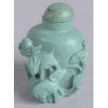 AN EARLY 20TH CENTURY CHINESE CARVED TURQUOISE SNUFF BOTTLE, 4.5cm high.