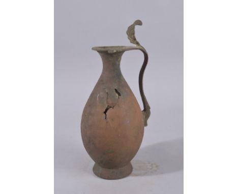 A 9TH-10TH CENTURY ABBASID BRONZE EWER, with leaf-formed terminal to the top of handle, 34cm high.
