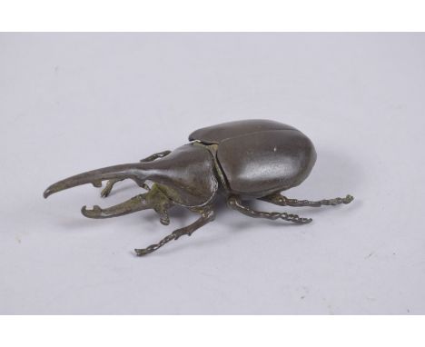 A BRONZE OKIMONO OF A RHINO HORN BEETLE.