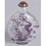 A 19TH CENTURY CHINESE PEKING GLASS SNUFF BOTTLE, with dragons and stylised clouds, 7.5cm high.