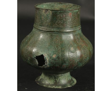 A 12TH-13TH CENTURY SELJUK KHORASAN SILVER INLAID VASE, with calligraphy and engraved scrolling vine, 15.5cm high.
