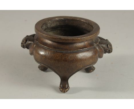 A CHINESE BRONZE TRIPOD CENSER, with lion face handles, the base with character mark, 17cm wide (handle to handle).