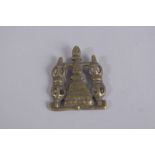 A TIBETAN BRASS PENDANT OR CLOTHING ORNAMENT.