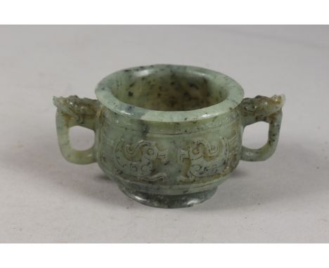 A FINE CHINESE CARVED JADE TWIN HANDLE CENSER, with archaic designs, applied collection sticker to base, 11cm handle to handl