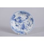 A CHINESE KANGXI PERIOD BLUE AND WHITE PORCELAIN SAUCER, painted with a hunting scene, mark to base,